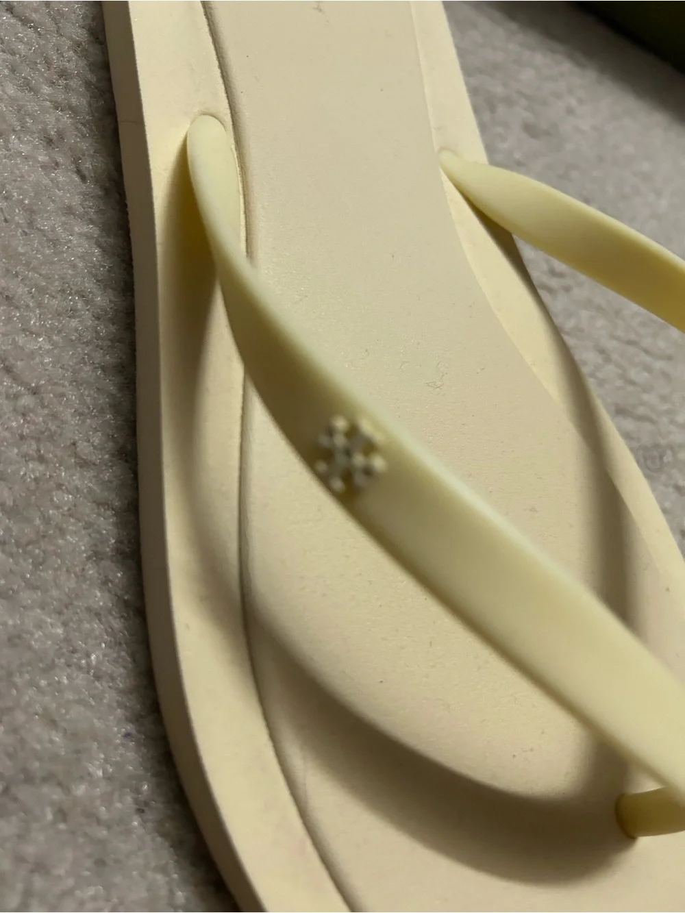 TORY BURCH KIRA padded flip flops in light yellow.